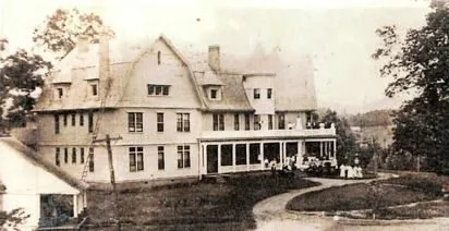 The gambrel-roofed Borden-Wheeler hotel across its lawn