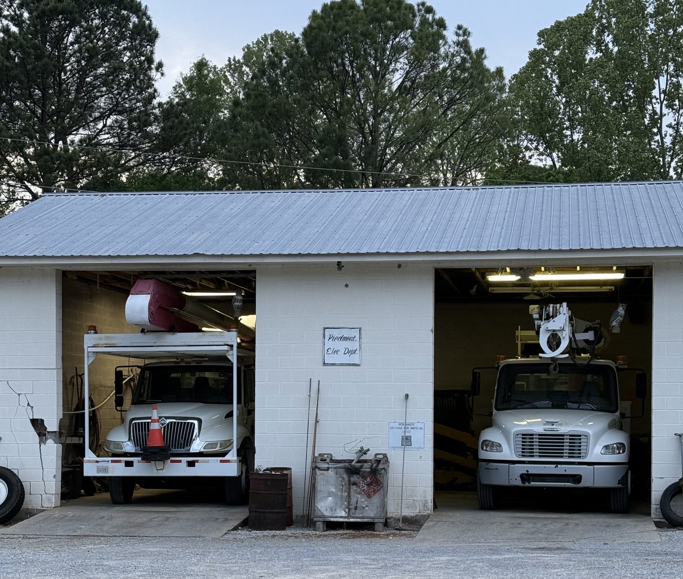 Two bucket trucks parked in the Piedmont Electric Department garage