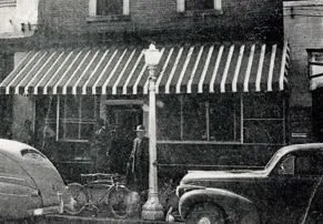 The Farmers and Merchants Bank storefront with a striped awning