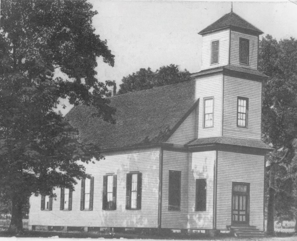 The white frame First Methodist Church with its square bell tower