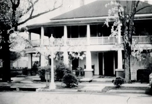 A white two-story building with stacked porches