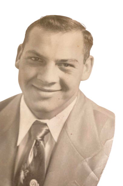 A smiling portrait of Joe Fagan in a suit and patterned tie