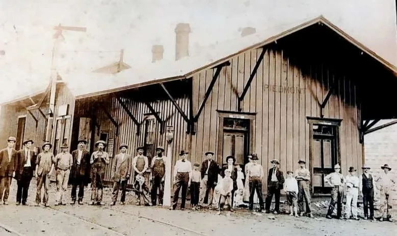 Railroad workers and townspeople lined up outside the wooden Piedmont depot