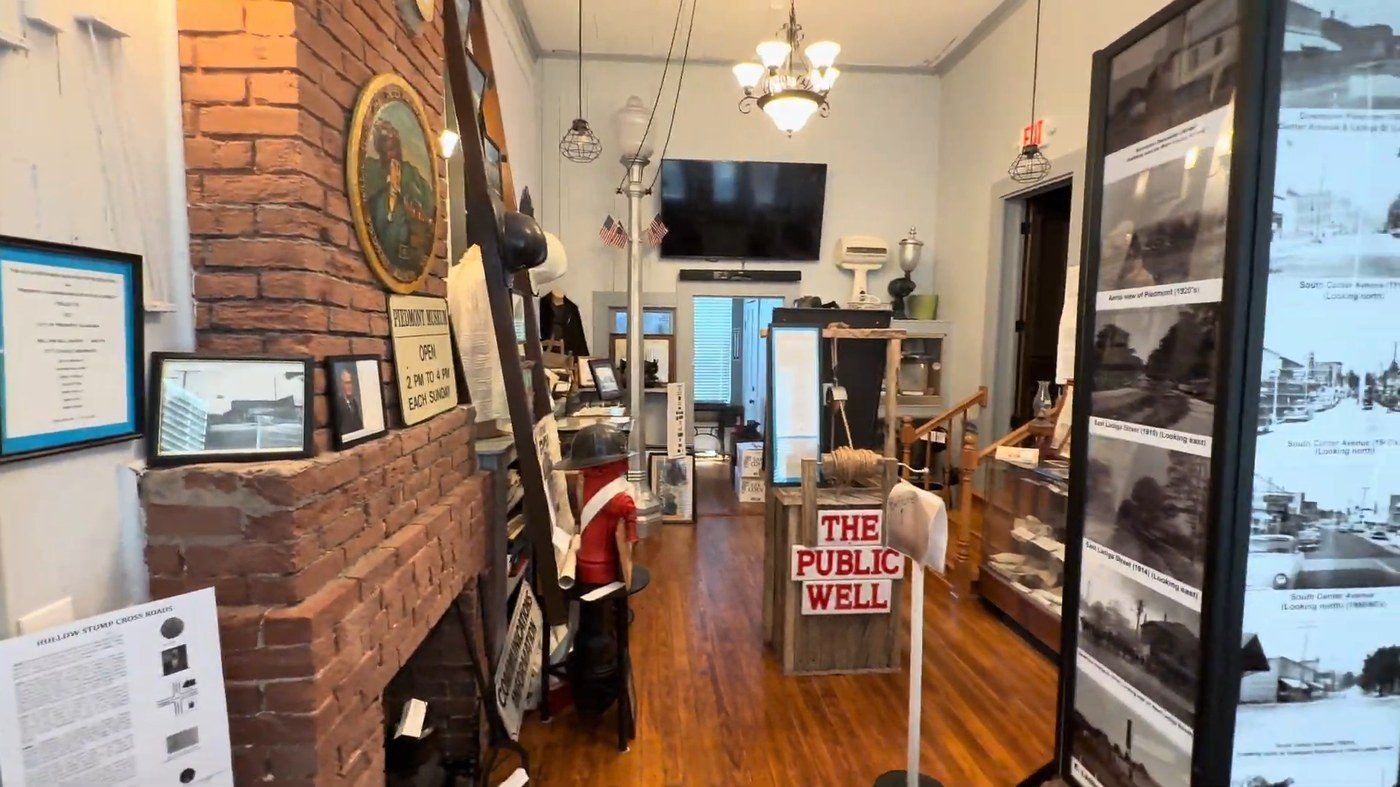 The finished Cross Plains room with its fireplace, exhibits, and the Public Well replica