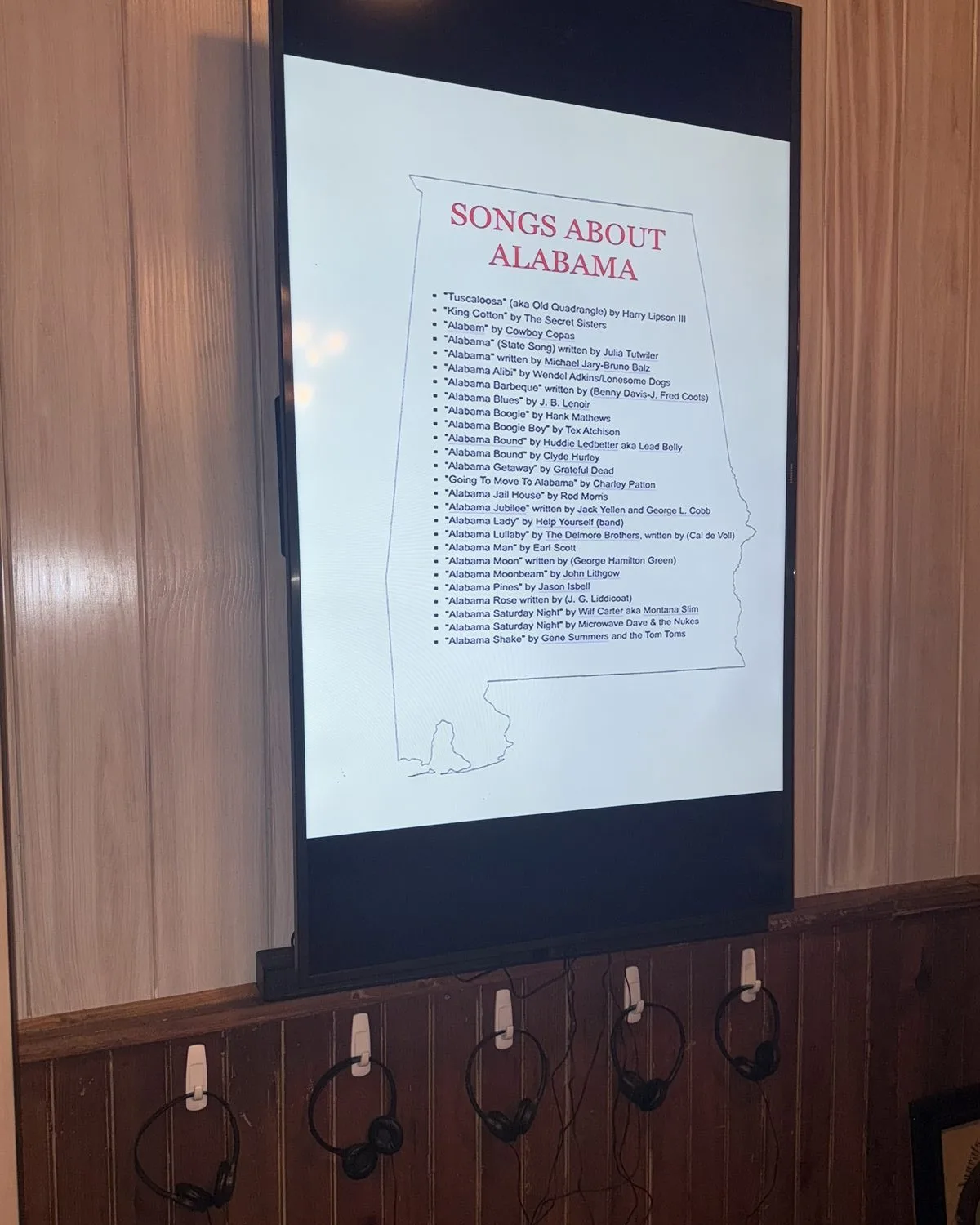 The Songs About Alabama listening station with its song list and headphones